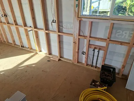 The extension framed up, with new water pipes coming through the floor