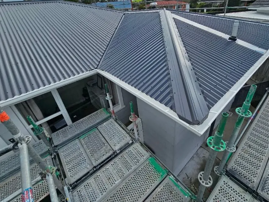 A house in Dargaville with its new corrugated roof on, seen from the scaffolding