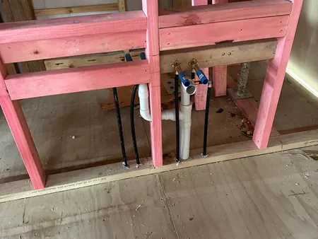 New water and waste pipework run straight and plumb through the new timber framing