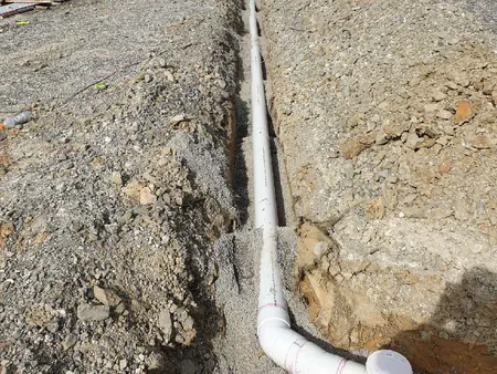 New sewer line laid in a trench across the site, heading for the council connection