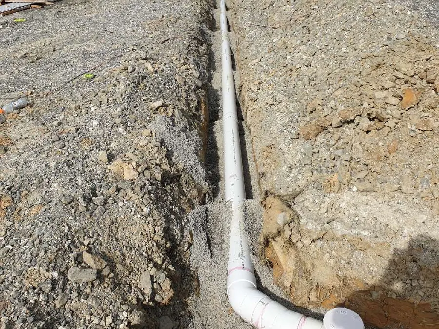 New sewer line laid in a trench across the site, heading for the council connection