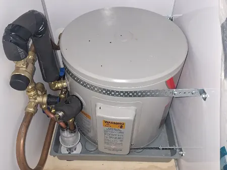 A new small hot water cylinder with valves, seismic strapping and safe tray