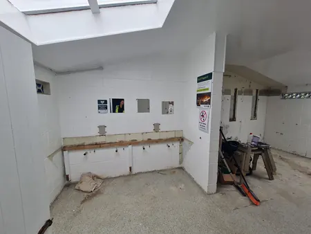 A Kai Iwi Lakes toilet block room stripped back, with the old basins and fittings removed