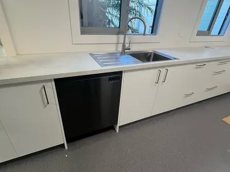 The finished staffroom kitchen with new benchtop, sink, mixer and dishwasher