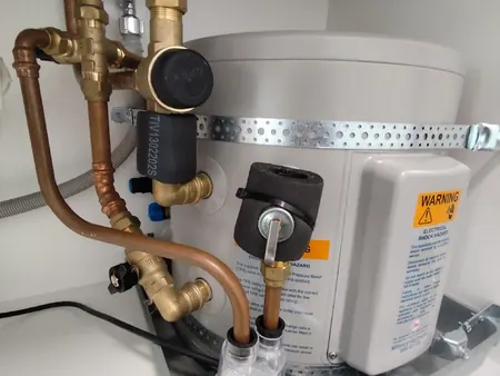New under-bench hot water cylinder with valves and safe tray