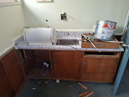 The old classroom kitchenette at Te Kura o Otangarei, with its hot water cylinder and sink disconnected