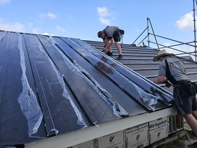 Two Stevens roofers laying a new roof