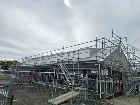 Scaffolding and temporary fencing around the Snow Bros showroom while it stayed open