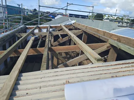 The showroom roof stripped back to the timber framing, with new underlay ready to go on