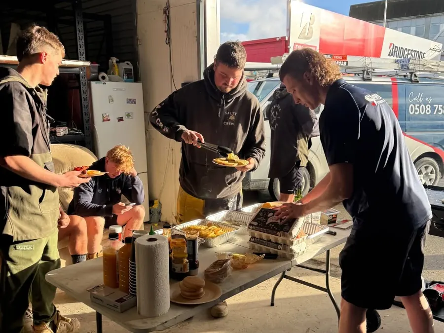 The Stevens team dishing up a cooked breakfast together at the workshop