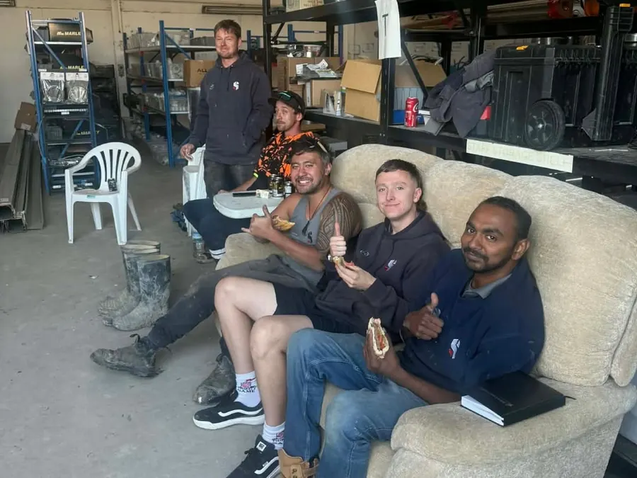 Some of the Stevens team on the workshop couch at lunch, thumbs up